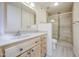 Bathroom featuring wood-look vanity, updated fixtures, and a glass-enclosed shower with designer tile at 5335 N 78Th St, Scottsdale, AZ 85250