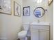 Cozy bathroom featuring a toilet, mirror, vanity and decorative fashion sketches on the wall at 5335 N 78Th St, Scottsdale, AZ 85250