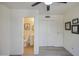 This bedroom boasts a private bathroom with a toilet, sink, storage cabinets and ceiling fan at 5335 N 78Th St, Scottsdale, AZ 85250