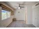 Bright bedroom features a ceiling fan, light gray flooring and a large window at 5335 N 78Th St, Scottsdale, AZ 85250