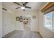 This bedroom features ceiling fan and access to living room through the hall at 5335 N 78Th St, Scottsdale, AZ 85250