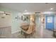 Inviting dining area with a wooden table and colorful chairs, open to the kitchen and front entrance at 5335 N 78Th St, Scottsdale, AZ 85250