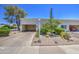 Inviting home showcasing a desert-style front yard, a covered carport, and mature desert landscaping at 5335 N 78Th St, Scottsdale, AZ 85250