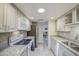 Well-lit kitchen with white cabinets, granite countertops, and stainless steel appliances and view to Gathering room at 5335 N 78Th St, Scottsdale, AZ 85250
