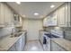Bright kitchen with white cabinetry, granite counters, subway tile backsplash and stainless steel appliances at 5335 N 78Th St, Scottsdale, AZ 85250