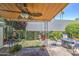 Inviting covered patio with comfortable seating, a fire pit, and lush greenery, perfect for relaxation and socializing at 5335 N 78Th St, Scottsdale, AZ 85250