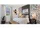 The room features a window, a bed, and a bedside table with decor at 5550 E Mearn Rd, San Tan Valley, AZ 85140