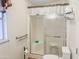 Bathroom featuring a glass enclosed shower with a built-in seat, grab bar, toilet, and frosted window at 5735 E Mcdowell Rd # 436, Mesa, AZ 85215