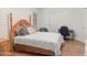 Cozy bedroom featuring a queen bed, laminate flooring, a bedside table, and a small work desk at 5735 E Mcdowell Rd # 436, Mesa, AZ 85215