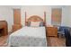Comfortable bedroom with wooden floors, a decorative headboard, and matching nightstands at 5735 E Mcdowell Rd # 436, Mesa, AZ 85215