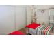 Spacious bedroom offering a glimpse into the bright white bathroom with toilet and shelving at 5735 E Mcdowell Rd # 436, Mesa, AZ 85215
