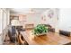 Open dining area featuring a wooden table, chairs, laminate flooring, and decor with natural light from large windows at 5735 E Mcdowell Rd # 436, Mesa, AZ 85215