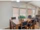 Dining room featuring a wooden table, chair set, laminate floor, and natural light from large windows at 5735 E Mcdowell Rd # 436, Mesa, AZ 85215