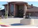 Charming brick building featuring mature desert landscaping and inviting entrance with elegant bronze statues at 5735 E Mcdowell Rd # 436, Mesa, AZ 85215