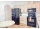 Classic kitchen with black appliances, ample cabinetry and countertop space, and easy access to dining at 5735 E Mcdowell Rd # 436, Mesa, AZ 85215