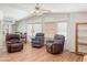 Bright living room with high ceilings, three recliners, laminate floors, and natural light from multiple windows at 5735 E Mcdowell Rd # 436, Mesa, AZ 85215