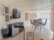 Enclosed patio with seating area and mounted television at 5735 E Mcdowell Rd # 436, Mesa, AZ 85215