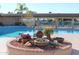 Sparkling pool with a unique fountain feature, surrounded by ample seating and lush landscaping at 5735 E Mcdowell Rd # 436, Mesa, AZ 85215