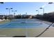 Professionally maintained tennis court surrounded by shade trees and community residences at 5735 E Mcdowell Rd # 436, Mesa, AZ 85215