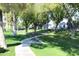 Serene walking path with benches nestled among lush greenery and mature trees for peaceful strolls at 5735 E Mcdowell Rd # 436, Mesa, AZ 85215