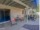 Covered back patio is beautifully furnished with a table set and lounge chairs, perfect for outdoor relaxation at 6639 E Pershing Ave, Scottsdale, AZ 85254