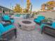 Spacious backyard featuring a stone fire pit and comfortable seating, creating an inviting outdoor gathering space at 6639 E Pershing Ave, Scottsdale, AZ 85254