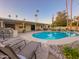 Backyard oasis featuring a pristine pool, poolside lounge chairs, and a manicured lawn for year-round enjoyment at 6639 E Pershing Ave, Scottsdale, AZ 85254