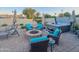 Relaxing backyard with a fire pit, comfortable seating, and a hot tub, perfect for outdoor entertaining at 6639 E Pershing Ave, Scottsdale, AZ 85254
