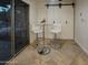 Stylish dining area with a modern glass table and white chairs, adjacent to sliding doors and barn doors at 6639 E Pershing Ave, Scottsdale, AZ 85254