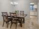 Traditional dining room features a dark wood table, four chairs, chandelier, and tile floors at 6639 E Pershing Ave, Scottsdale, AZ 85254