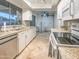 Bright kitchen with stainless steel appliances and granite counters offers modern comfort and functionality at 6639 E Pershing Ave, Scottsdale, AZ 85254