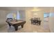 Open-concept room with billiard table and dining area in naturally lit space at 6639 E Pershing Ave, Scottsdale, AZ 85254