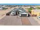 Aerial view of a single-story home featuring a brick driveway and a two-car garage at 8226 W Swansea Dr, Arizona City, AZ 85123