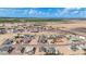 A wide aerial shot of a community with neatly arranged homes, desert terrain, and agricultural fields in the distance at 8226 W Swansea Dr, Arizona City, AZ 85123