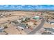 Community aerial view showcasing single-story home with a brick driveway in a desert community at 8226 W Swansea Dr, Arizona City, AZ 85123