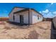 Exterior view of home with covered patio and low-maintenance backyard, ready for landscaping at 8226 W Swansea Dr, Arizona City, AZ 85123