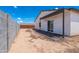 Home's backyard showcasing block wall fencing and a quaint, brick patio space at 8226 W Swansea Dr, Arizona City, AZ 85123