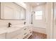 Elegant bathroom featuring double sinks, sleek fixtures, subway tile, and a tub-shower combo at 8226 W Swansea Dr, Arizona City, AZ 85123