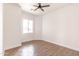 Bedroom featuring wood-look tile flooring, ceiling fan, and white walls at 8226 W Swansea Dr, Arizona City, AZ 85123