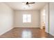 Bedroom featuring wood-look tile flooring and an arched doorway leading to the bathroom at 8226 W Swansea Dr, Arizona City, AZ 85123