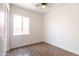Bedroom showcasing wood-look tile flooring, white walls and window at 8226 W Swansea Dr, Arizona City, AZ 85123