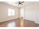 Bright bedroom boasts wood-look tile floors, ceiling fan, and an ensuite bathroom entrance at 8226 W Swansea Dr, Arizona City, AZ 85123