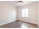 Empty bedroom with wood-look tile flooring, white walls and window at 8226 W Swansea Dr, Arizona City, AZ 85123