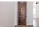 Elegant solid wood front door with a decorative design, adding warmth and character to the home's entrance at 8226 W Swansea Dr, Arizona City, AZ 85123
