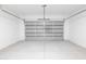 Spacious and clean two-car garage featuring a new metal door and neutral gray flooring at 8226 W Swansea Dr, Arizona City, AZ 85123