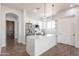 Modern kitchen with white cabinets, quartz countertops, stainless steel appliances, and a stylish center island at 8226 W Swansea Dr, Arizona City, AZ 85123