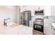 Modern kitchen featuring an island with a sink, stainless steel appliances, and white subway tile backsplash at 8226 W Swansea Dr, Arizona City, AZ 85123