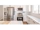 Well-equipped kitchen with stainless steel appliances, white cabinetry, granite countertops, and subway tile backsplash at 8226 W Swansea Dr, Arizona City, AZ 85123