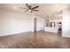 Bright living room featuring wood-look tile flooring, recessed lighting, and a modern ceiling fan at 8226 W Swansea Dr, Arizona City, AZ 85123