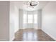 Bright, airy living room with hardwood floors, a modern ceiling fan, and large windows offering ample natural light at 8226 W Swansea Dr, Arizona City, AZ 85123